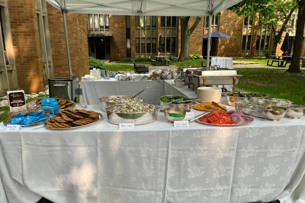 Table set up with BBQ foods across it.